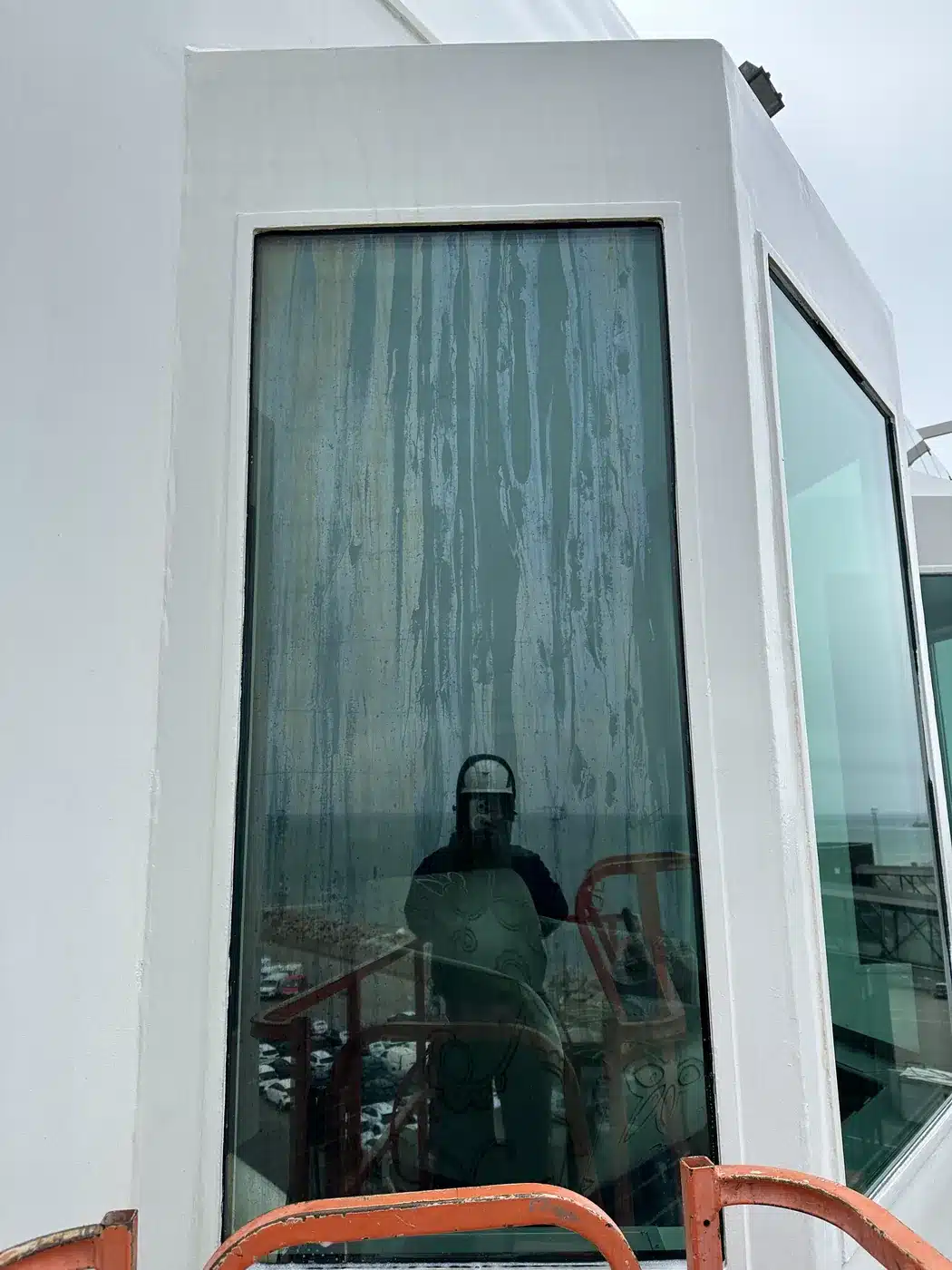 Window on MS Stavangerfjord before polishing, with streaks and deposits